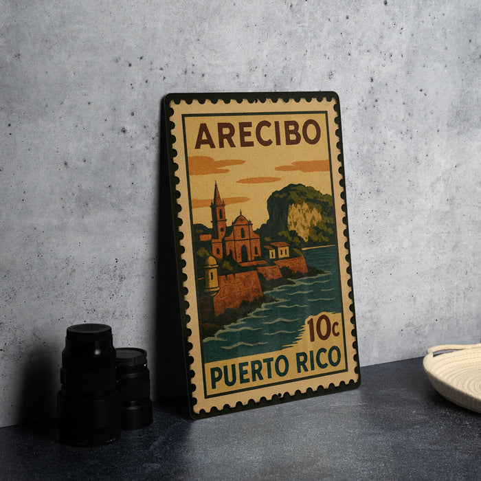 A vintage Puerto Rico postage stamp featuring a coastal town scene, placed on a countertop next to some black camera lenses.