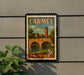 A vintage postage stamp from Indiana featuring a bridge and a clock tower, mounted on a wall next to a plant.