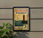 A vintage-style postage stamp from Wisconsin, featuring a lighthouse and a sailboat, is displayed on a wall.