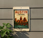 A sign featuring the image of the city of Austin, Texas, with a stamp-like border and a depiction of the city's skyline.