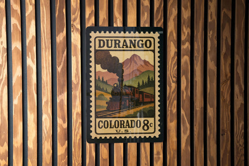 A vintage postage stamp from Durango, Colorado, featuring a steam locomotive on a mountain landscape.