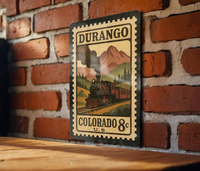 A vintage-style postage stamp depicting a train on a mountain, mounted on a brick wall.