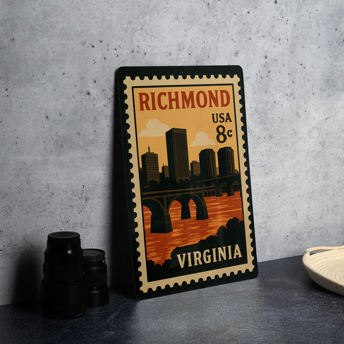 A vintage-style postage stamp from Virginia, featuring a cityscape and a bridge, is displayed on a table.