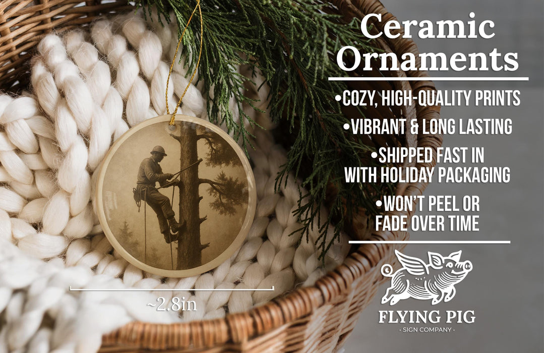 Ceramic ornaments, featuring a vintage photograph of a man climbing a tree, are displayed in a basket with a sprig of greenery.