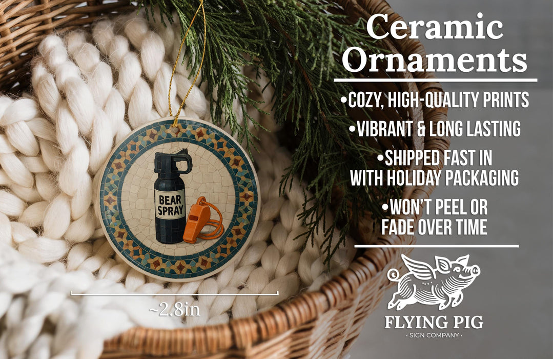 Ceramic ornaments, featuring a bear spray bottle and a whistle, are displayed in a woven basket.