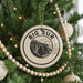 A Christmas tree decorated with ornaments, including a large circular ornament with the text "BIG SUR" and a bridge illustration.