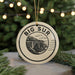 A ceramic ornament with the text "BIG SUR" and an illustration of a bridge, surrounded by greenery and twinkling lights.