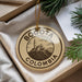 A circular ornament with the text "BOGOTA COLOMBIA" printed on it, surrounded by a decorative string.