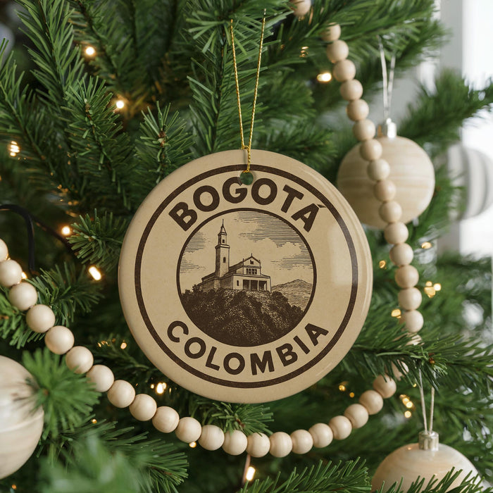 A circular ornament on a Christmas tree, featuring the text "BOGOTA COLOMBIA" and an illustration of a building.