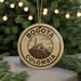 A circular ornament with the text "BOGOTA COLOMBIA" and an illustration of a building on a hill, hanging from a string.
