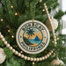 A round ornament on a Christmas tree with the text "BORACAY PHILIPPINES" and a palm tree design.