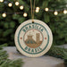 A circular ornament with the text "Brasilia Brasil" and an illustration of the Christ Church Cathedral in Brasilia, Brazil, is displayed in front of a Christmas tree with twinkling lights.