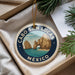 A decorative ornament with a circular design featuring a scenic image of Cabo San Lucas, a famous landmark in Mexico.