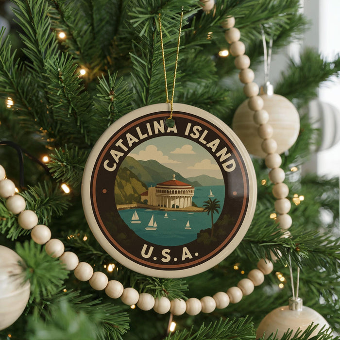 A circular ornament on a Christmas tree, featuring a scenic image of Catalina Island, with the text "CATALINA ISLAND U.S.A."