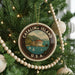A circular ornament on a Christmas tree, featuring a scenic image of Catalina Island, with the text "CATALINA ISLAND U.S.A."