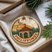 A round ornament with the text "CEBU PHILIPPINES" and an illustration of a church or cathedral, hanging from a string.