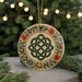 A decorative ornament with a Celtic knot design is displayed on a table, surrounded by pine branches and twinkling lights.