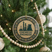 A Christmas tree decorated with ornaments, including a circular ornament with a chemical engineer logo.
