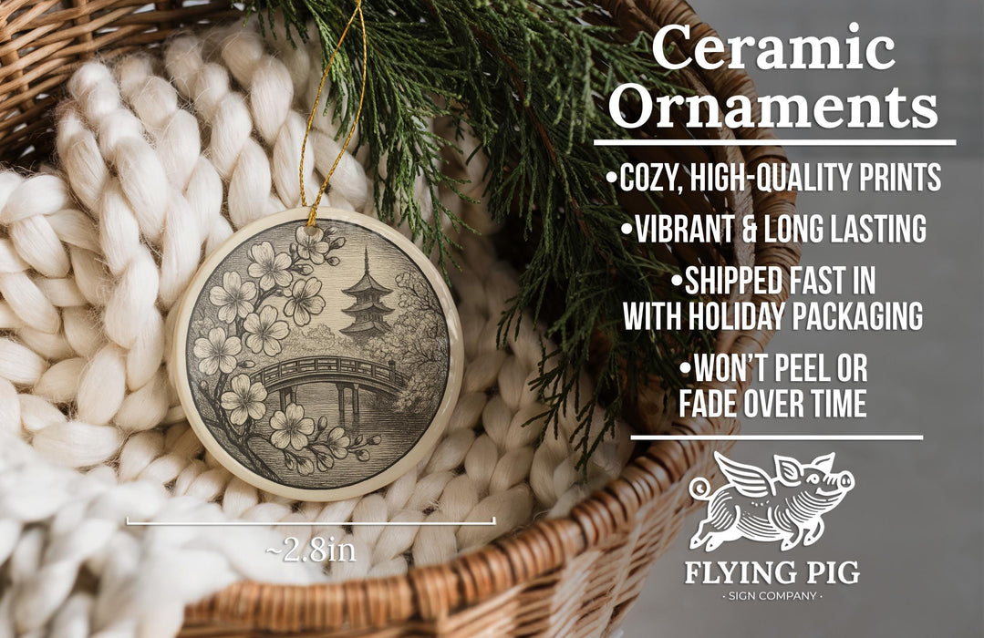 Ceramic ornaments, featuring a black and white illustration of a bridge and flowers, are displayed in a woven basket.