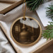 A round ornament with a black and white image of a distillery or laboratory setting, featuring a distillery still, a barrel, and other equipment.