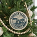 A circular ornament on a Christmas tree, featuring the text "DUBROVNIK CHANNEL CROATIA" and an illustration of a castle or fort.