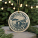 A circular ornament with the text "DUBROVNIK CHANNEL CROATIA" and an illustration of a coastal town, surrounded by Christmas lights.