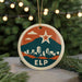 A round ornament with a cityscape design and a star, hanging from a string.