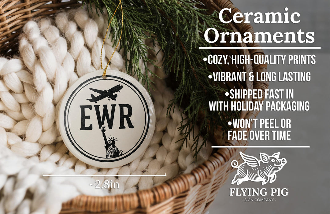 Ceramic ornaments, featuring a ceramic ornament with the letters "EWR" and a small image of a pig, are displayed in a woven basket.