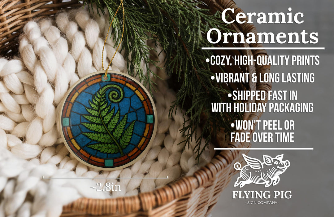 Ceramic ornaments, featuring a stained glass design of a fern, are displayed in a woven basket.