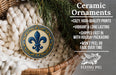 Ceramic ornaments, featuring a fleur-de-lis design, are displayed in a wicker basket.