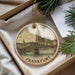 A round ornament with a picture of the Frankfurter Bridge in Frankfurt, Germany, hanging from a string.