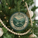 A Christmas tree decorated with ornaments, including a circular ornament with the text "KILLARNEY NATIONAL PARK IRELAND" and a scenic landscape.