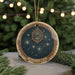 A round ornament with a starry night sky design and the word "PLEIADES" written on it, hanging from a string.