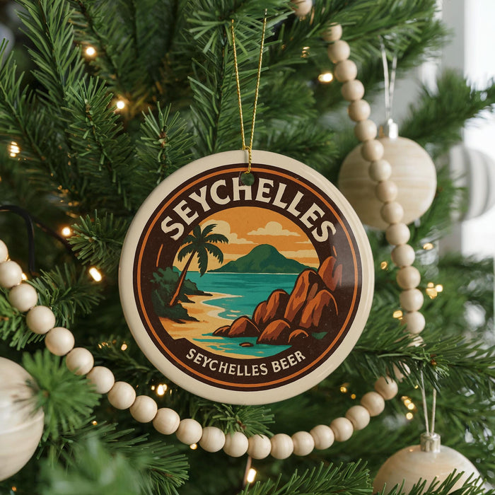 A round ornament on a Christmas tree, featuring a tropical beach scene with palm trees and a mountain in the background.