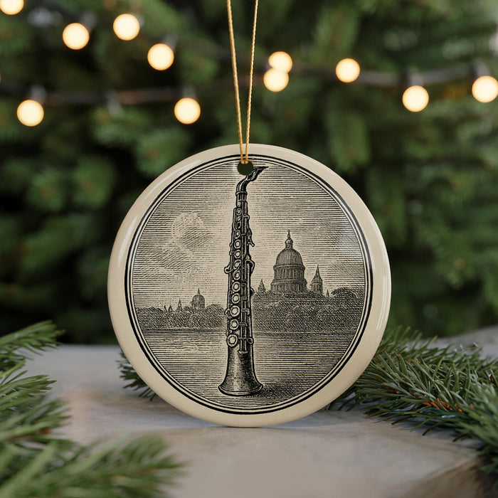 A round ornament featuring a saxophone and a city skyline, with a string of lights in the background.