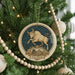 A decorative ornament on a Christmas tree, featuring a bull with horns and the word "Taurus" written below it.