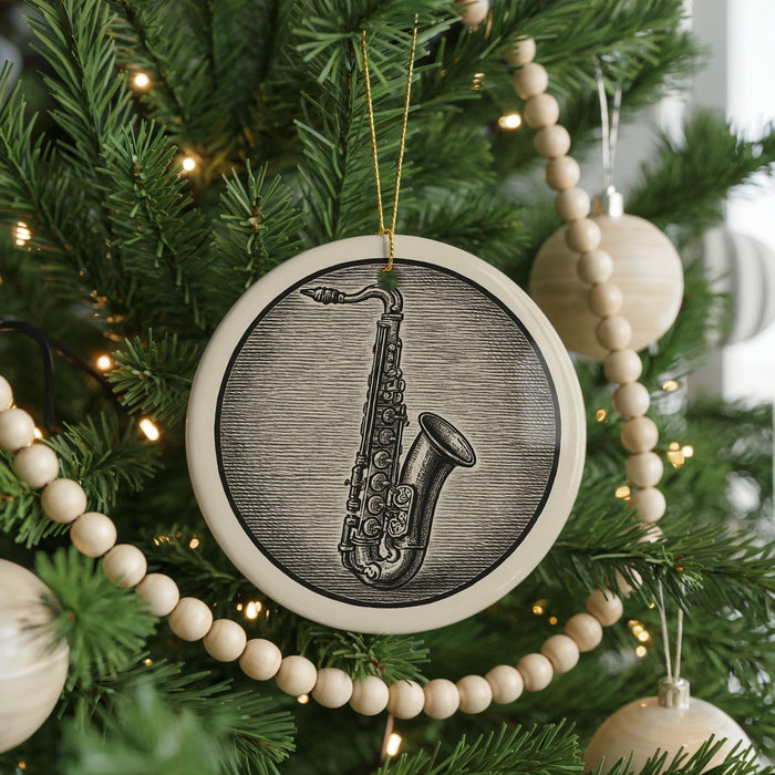 A Christmas tree decorated with ornaments, including a large circular ornament featuring a saxophone design.
