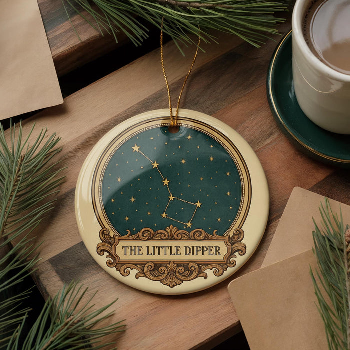 a decorative ornament with a starry night sky design, placed on a wooden surface alongside a cup of coffee and some pine branches.