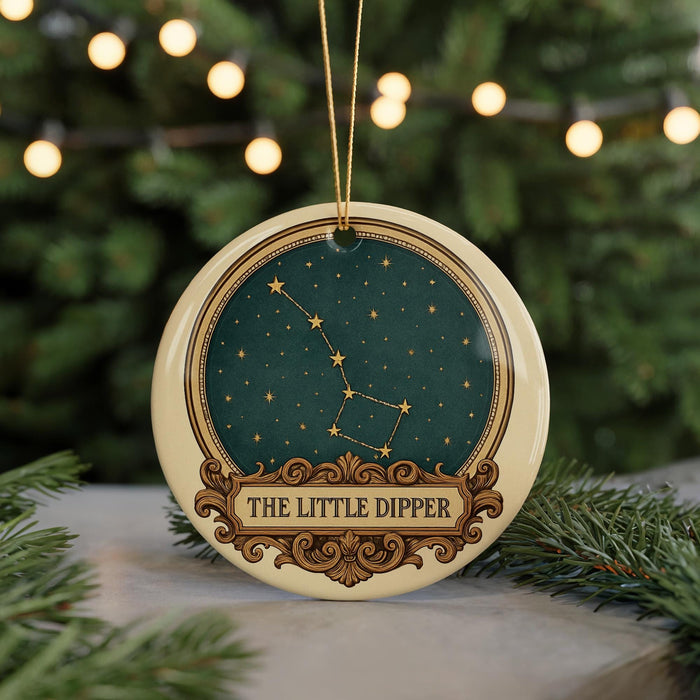 A circular ornament with a starry night sky design and the text "THE LITTLE DIpper" on it, hanging from a string.