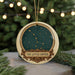 A circular ornament with a starry night sky design and the text "THE LITTLE DIpper" on it, hanging from a string.