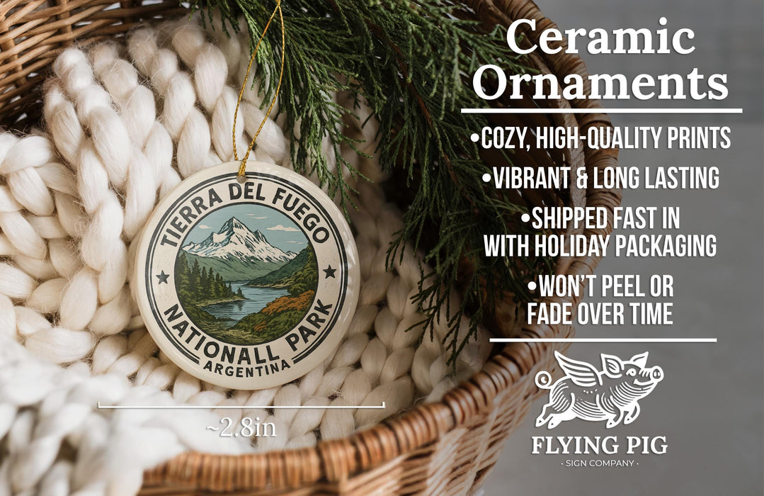 Ceramic ornaments, featuring a round ornament with a mountain landscape and text, are displayed in a woven basket.