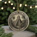 A circular ornament featuring a temple and palm trees, with the text "Tikal National Park Guatemala" around the edge.