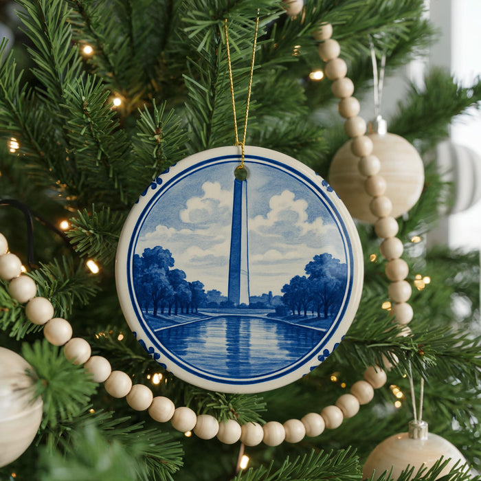 A Christmas tree decorated with ornaments, including a blue and white ornament featuring the Washington Monument.