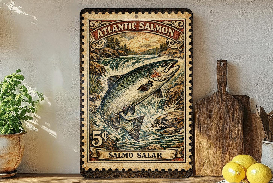 A vintage-style metal sign depicting a salmon leaping out of a river, with the text "ATLANTIC SALMON" and "SALMO SALAR" printed on it. The sign is mounted on a wall, and there are some kitchen utensils and a potted plant visible in the background.