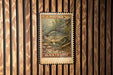 A U.S. postage stamp featuring a black crappie fish, which is a type of fish commonly used as a fishing lure.