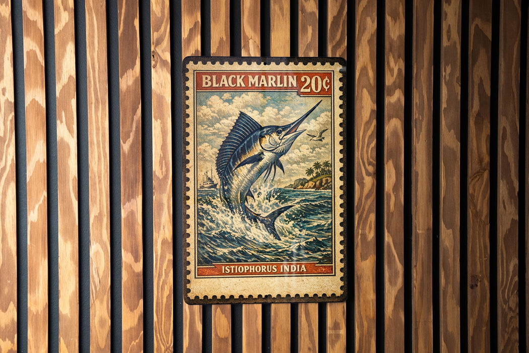 A vintage-style postage stamp featuring a large blue marlin fish, with the text "BLACK MARLIN 20¢" and "ISTOPHORUS INDIA" printed on it. The stamp is displayed on a wooden wall with vertical slats.