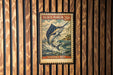 A vintage-style postage stamp featuring a large blue marlin fish, with the text "BLACK MARLIN 20¢" and "ISTOPHORUS INDIA" printed on it. The stamp is displayed on a wooden wall with vertical slats.