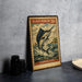 A vintage-style metal stamp depicting a black marlin fish, with text indicating it is worth 20 cents.