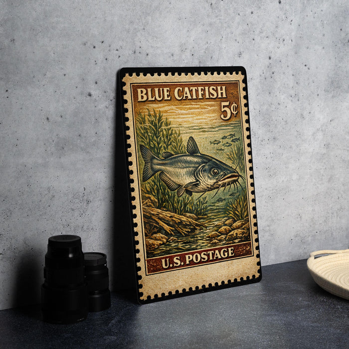 A vintage-style postage stamp featuring a blue catfish, with the text "BLUE CATFISH 5¢" and "U.S. POSTAGE" printed on it.