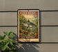 A vintage-style postage stamp featuring a blue catfish, mounted on a wall next to a plant.